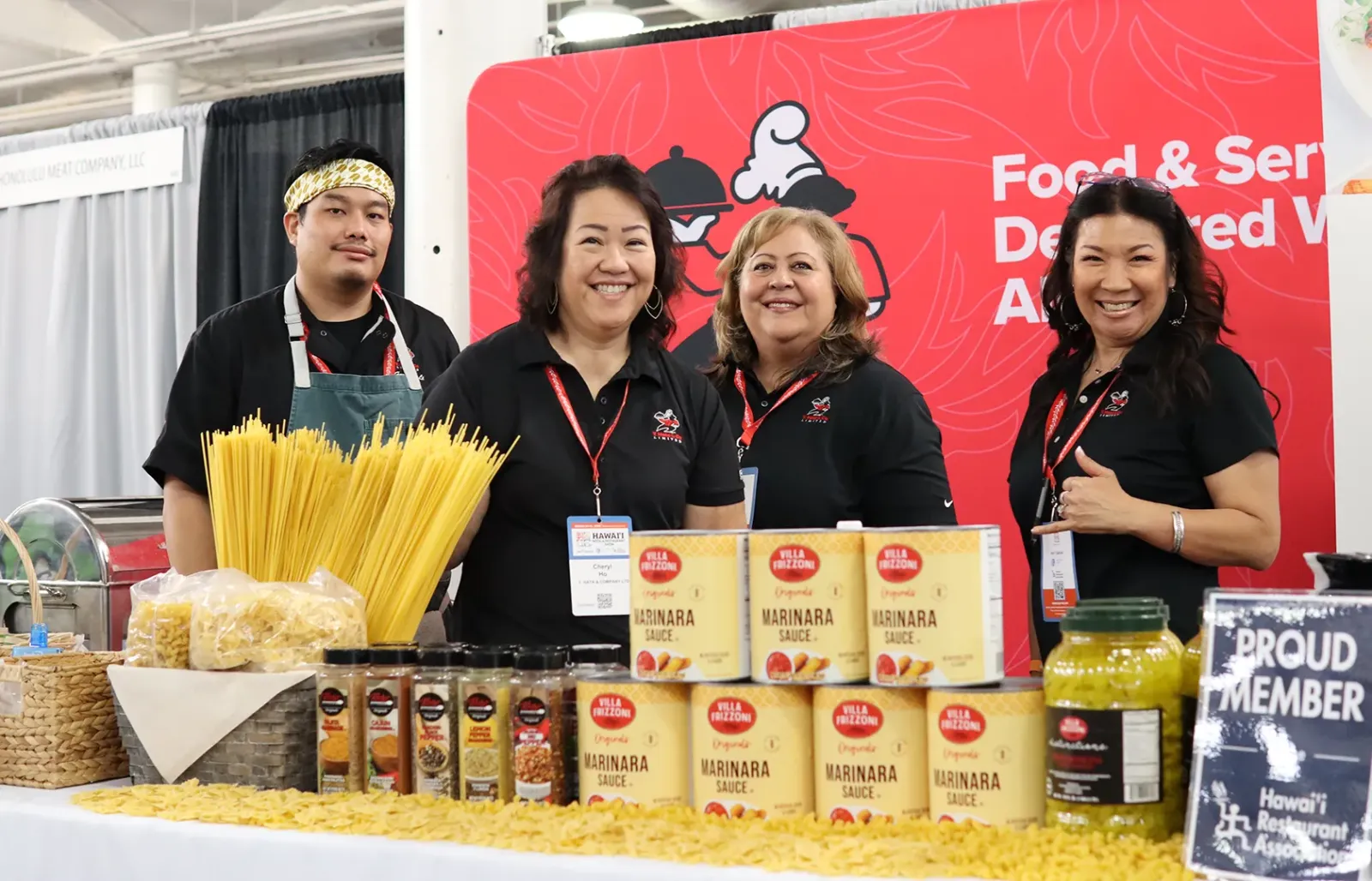 An exhibitor team at their pasta and sauce booth